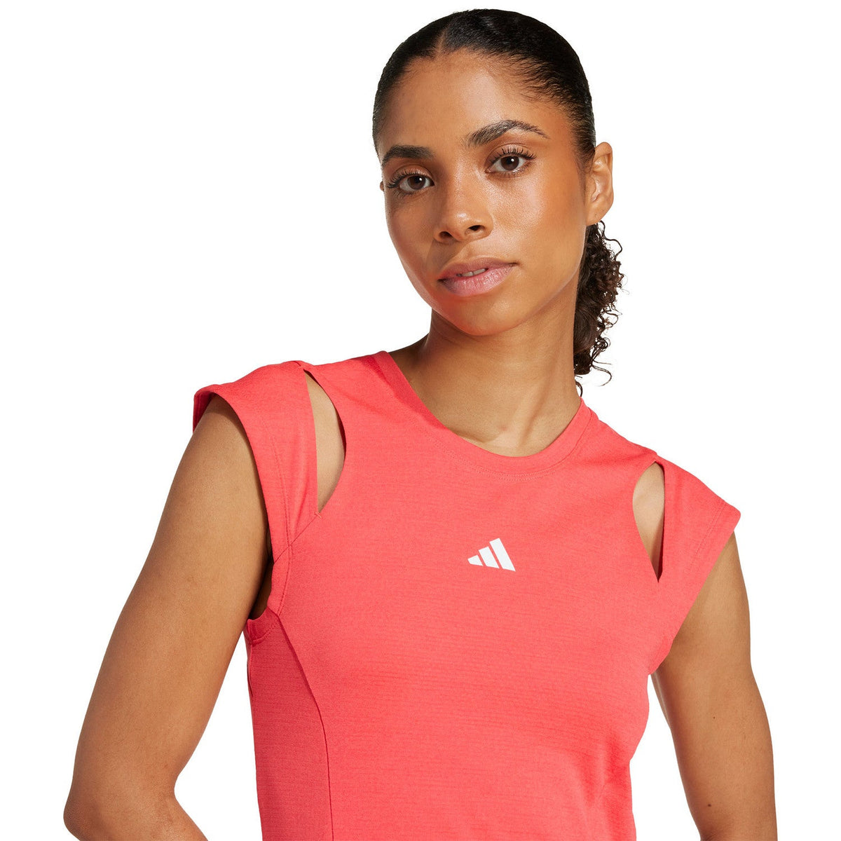 Close-up of the upper part of the coral-red Adidas Dress Pro with a white logo on the chest