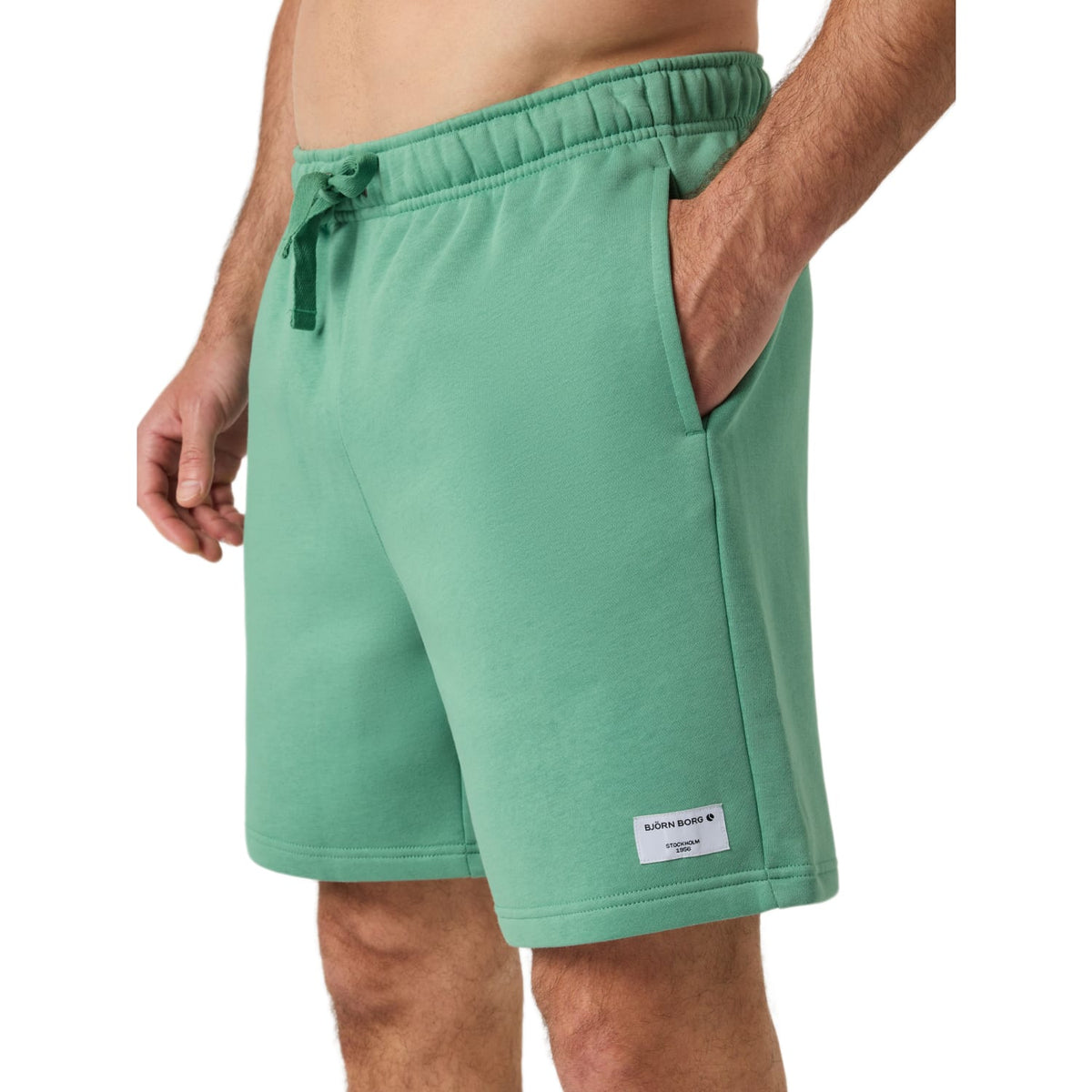 Zijaanzicht van de mintgroene Bjorn Borg Centre Sweatshorts met steekzak en wit label