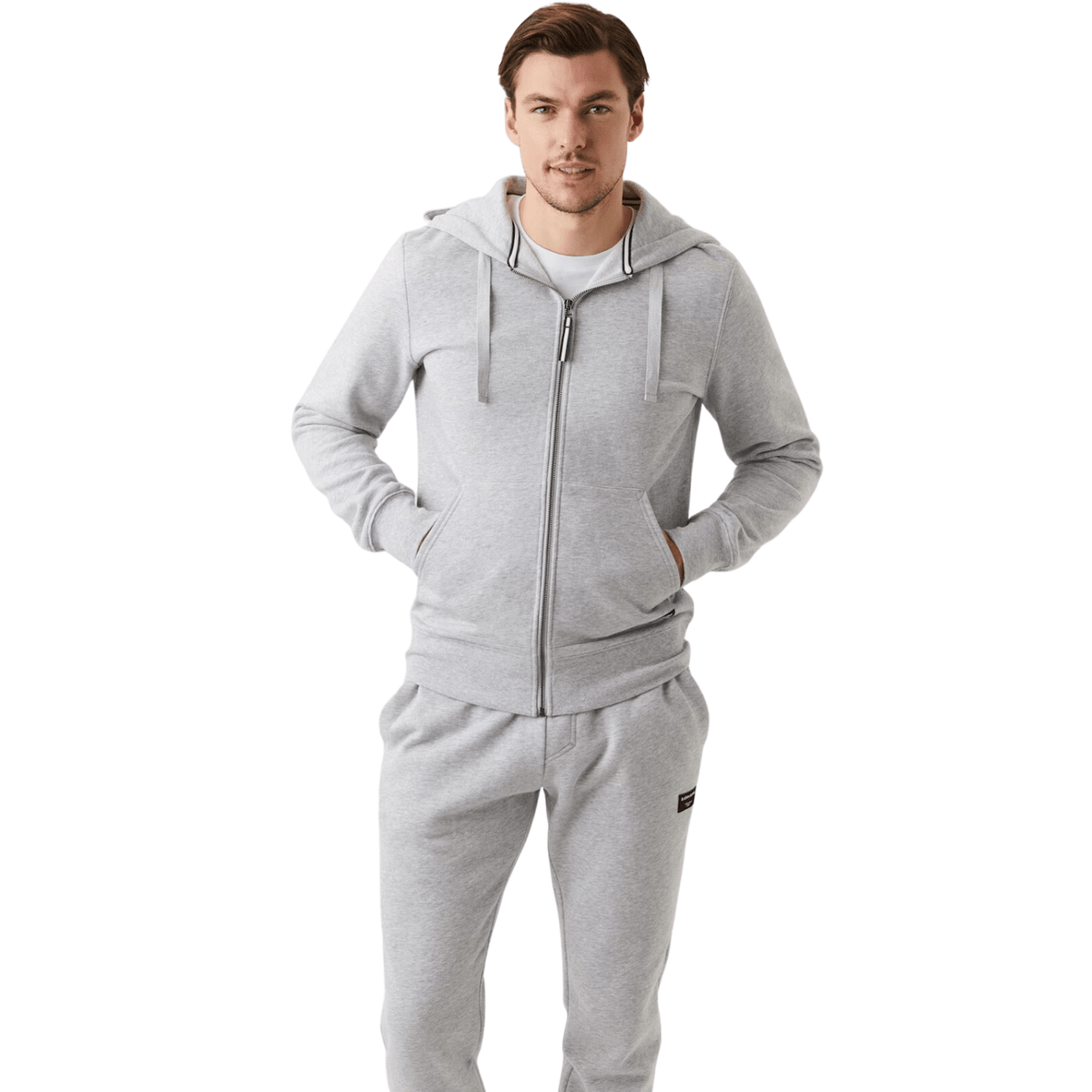 Herenmodel draagt de lichtgrijze Bjorn Borg Centre Zip Hoodie met bijpassende broek