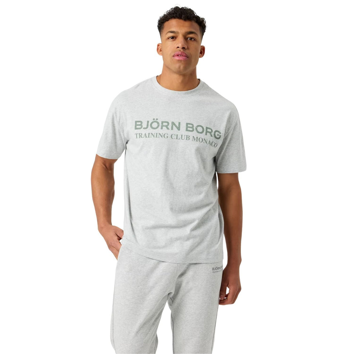 Herenmodel draagt het lichtgrijze Bjorn Borg Classic Print T-shirt met grijze joggingbroek