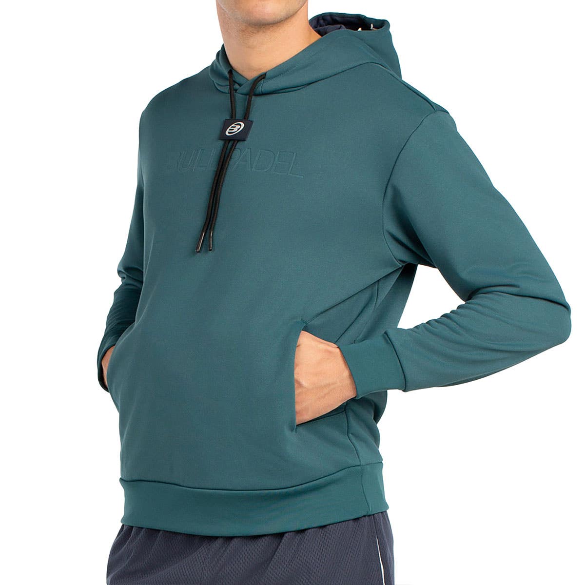 Zijaanzicht van de petrolkleurige Bullpadel Hoodie Binee, hand in de steekzak