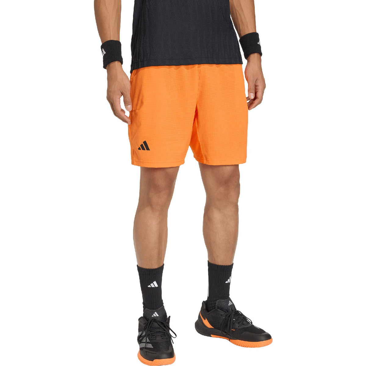 Zijaanzicht van de oranje Adidas Ergo short met split in de pijp