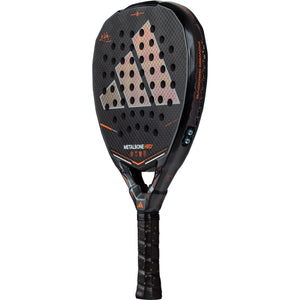 Adidas Metalbone HRD+ 3.5 padelracket licht gekanteld met oranje opdruk op zwart carbon