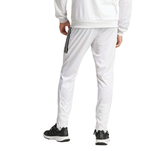Model draagt de witte Adidas 3-Stripes broek met zwarte sportschoenen, zijaanzicht