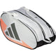 Zijaanzicht van de witte Adidas Racketbag Control 2026 met oranje accenten en grijs logo.
