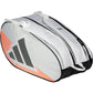 Zijaanzicht van de witte Adidas Racketbag Control 2026 met oranje accenten en grijs logo.