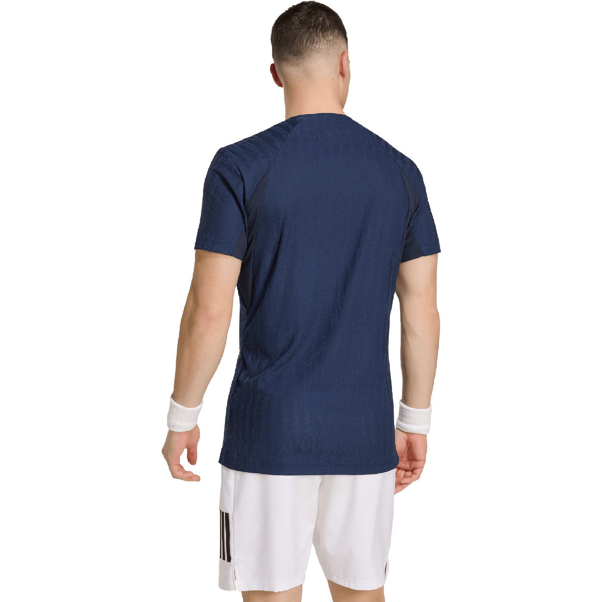 Achterzijde van het donkerblauwe Adidas Freelift T-shirt met witte short