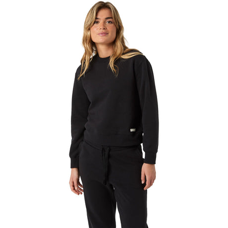 Damesmodel draagt het zwarte Bjorn Borg Centre Sweatshirt W met zwarte joggingbroek