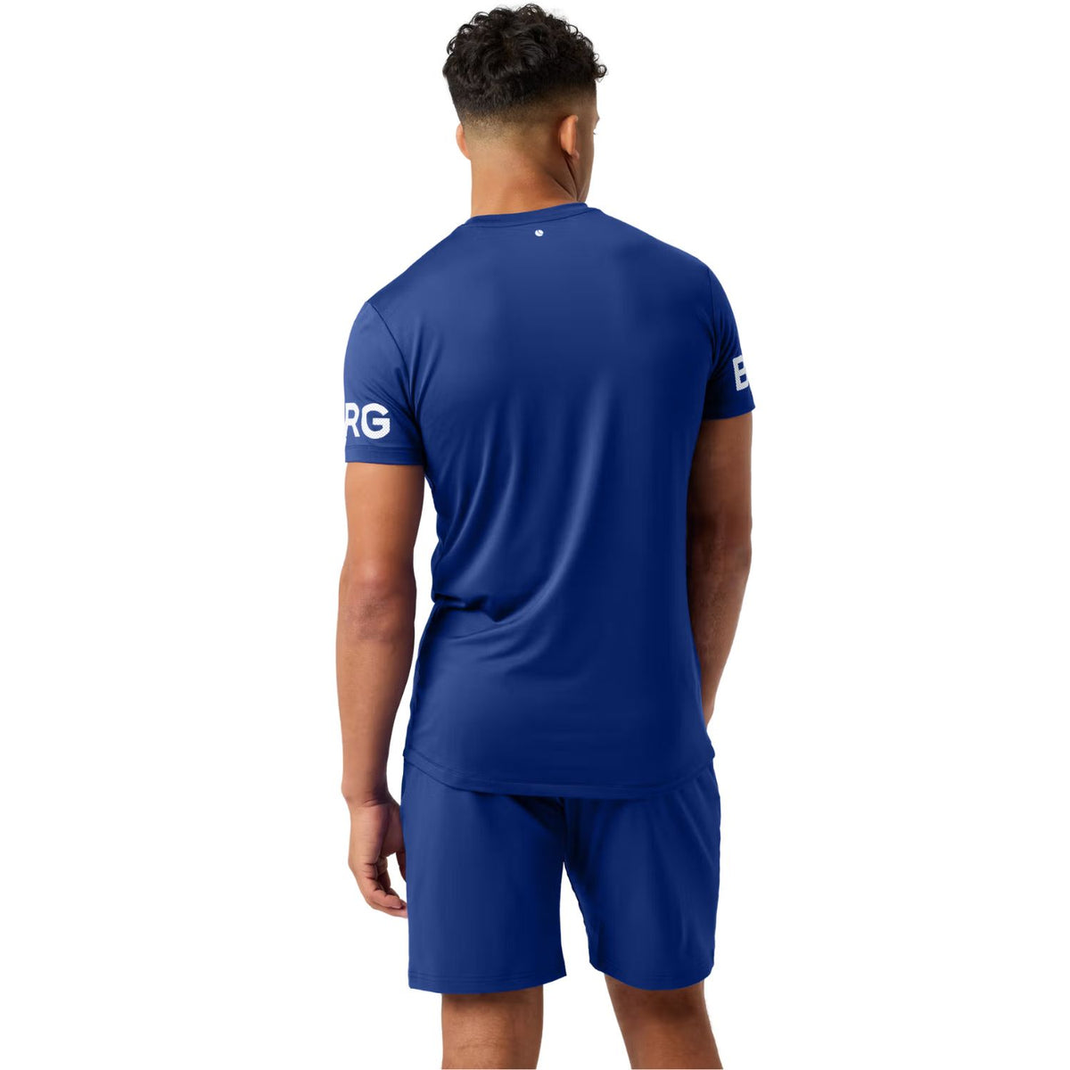 Model draagt het koningsblauwe Bjorn Borg T-shirt, halfaanzicht van achteren