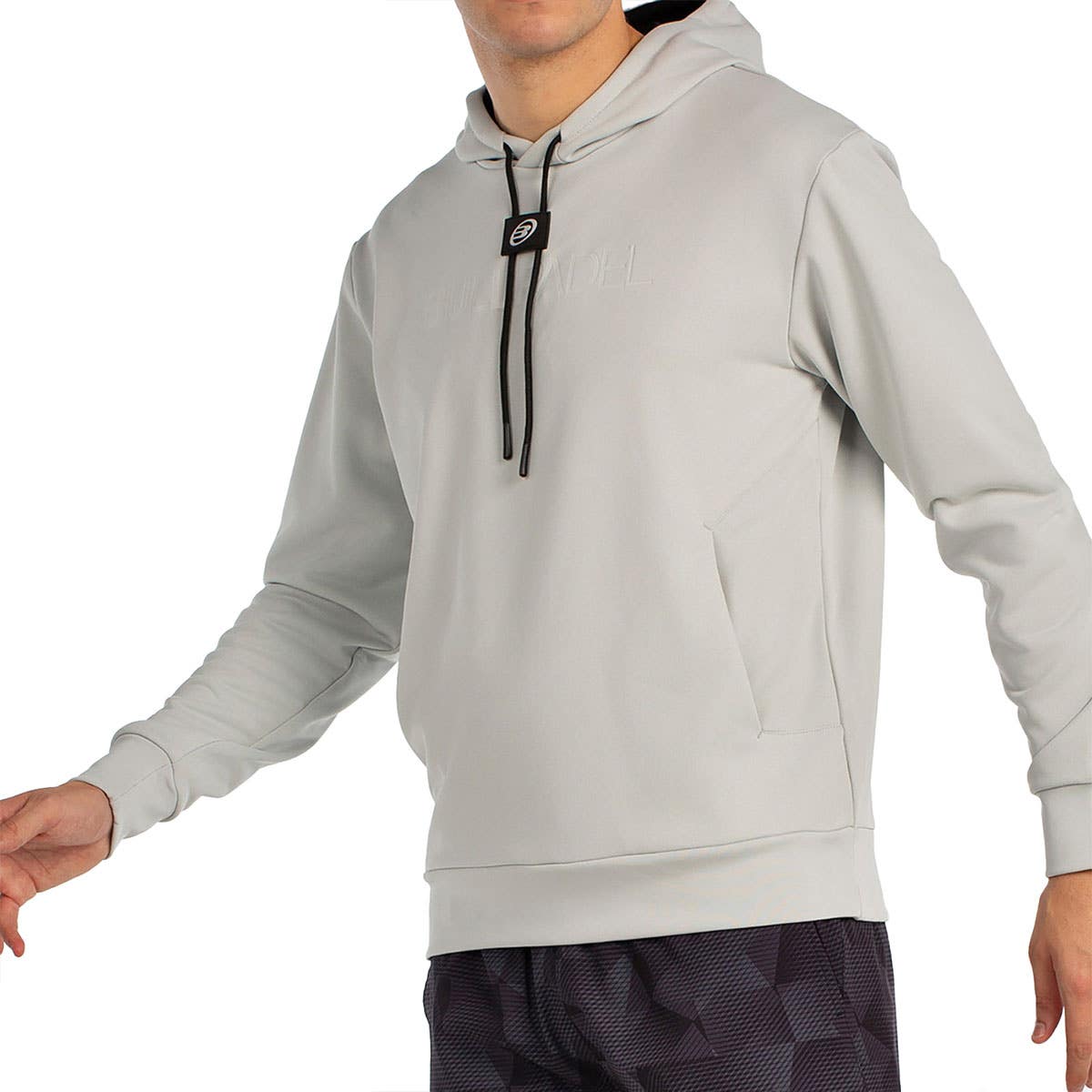 Zijaanzicht van de lichtgrijze Bullpadel Hoodie Binee met steekzak op het voorpand