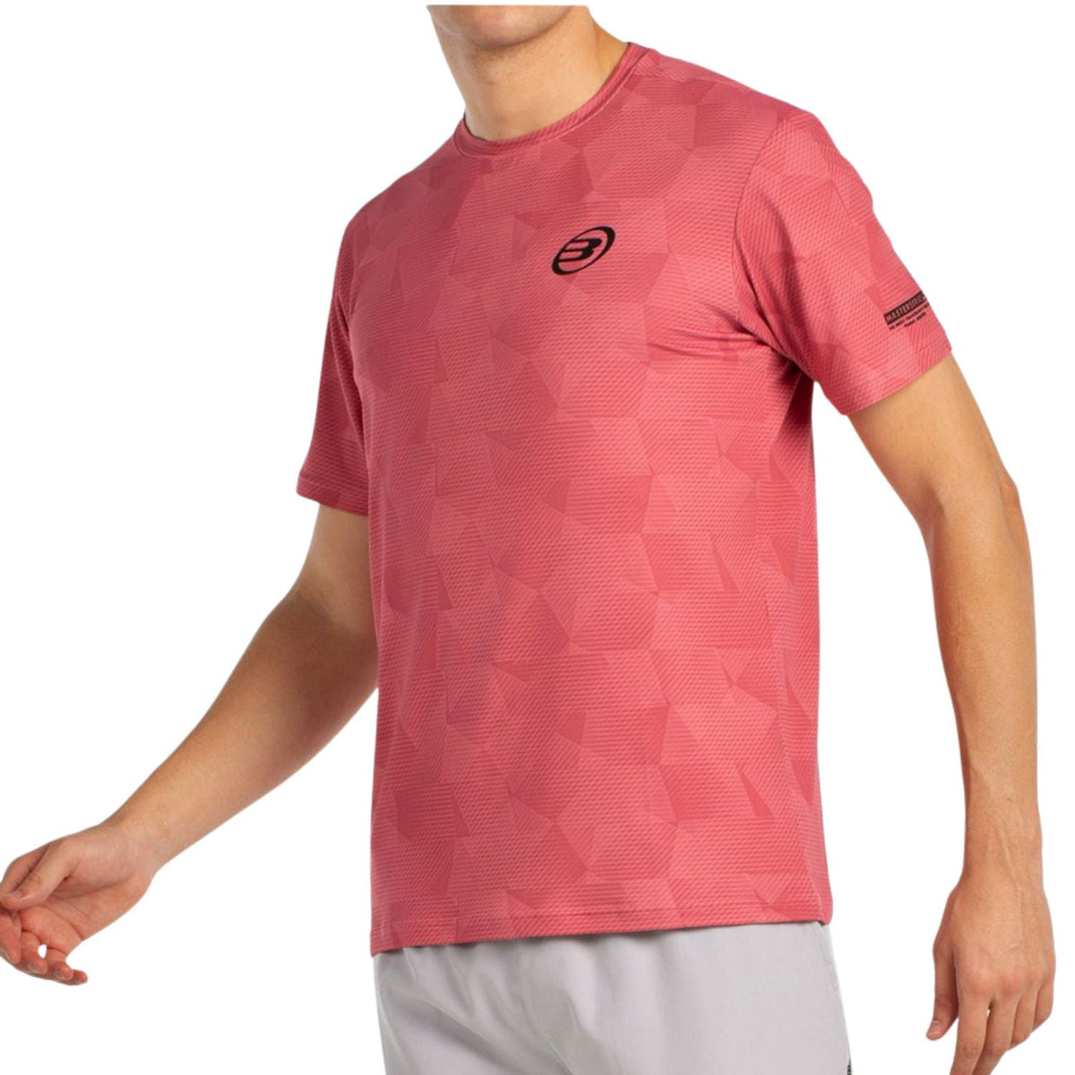 Schuin aanzicht van het koraalroze Bullpadel T-Shirt Macondo met vlakkenprint