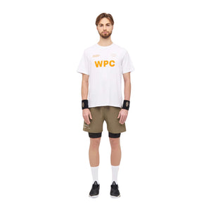 Model draagt de olijfgroene Cuera Active Globe short met wit WPC T-shirt en polsbandjes