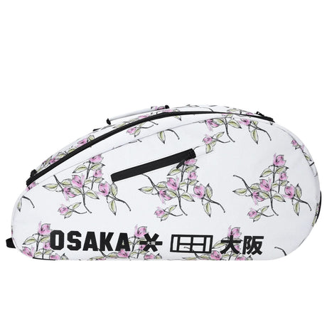 Zijaanzicht van de witte Osaka Sports padeltas met roze bloesemprint en zwarte rits